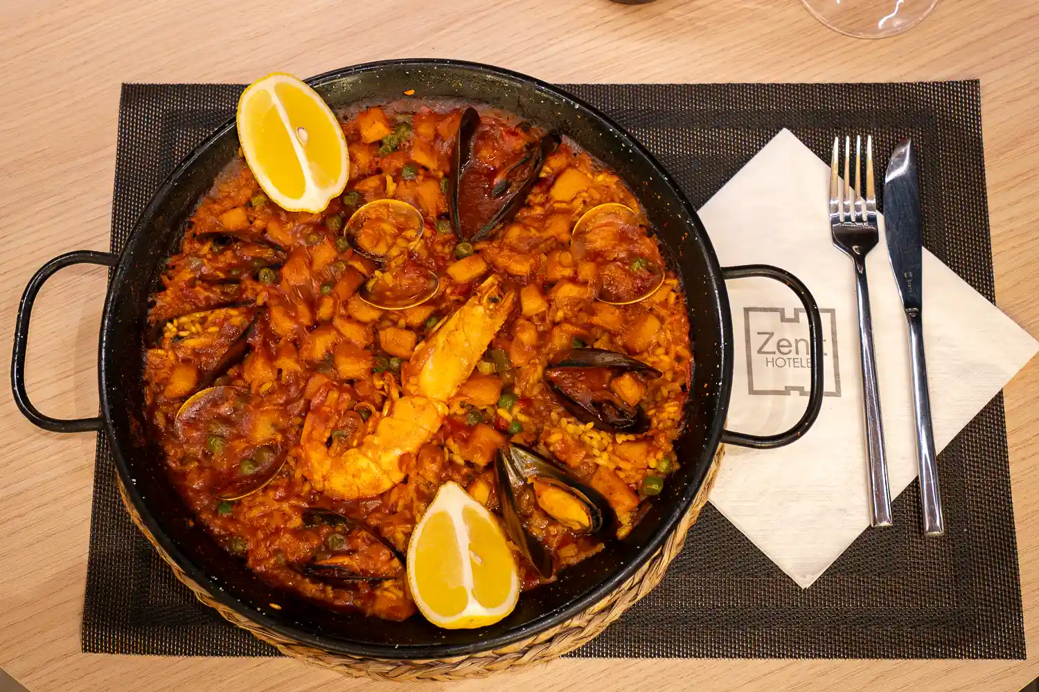 Paella de marisco con mejillones, almejas, cigala y dos gajos de limón